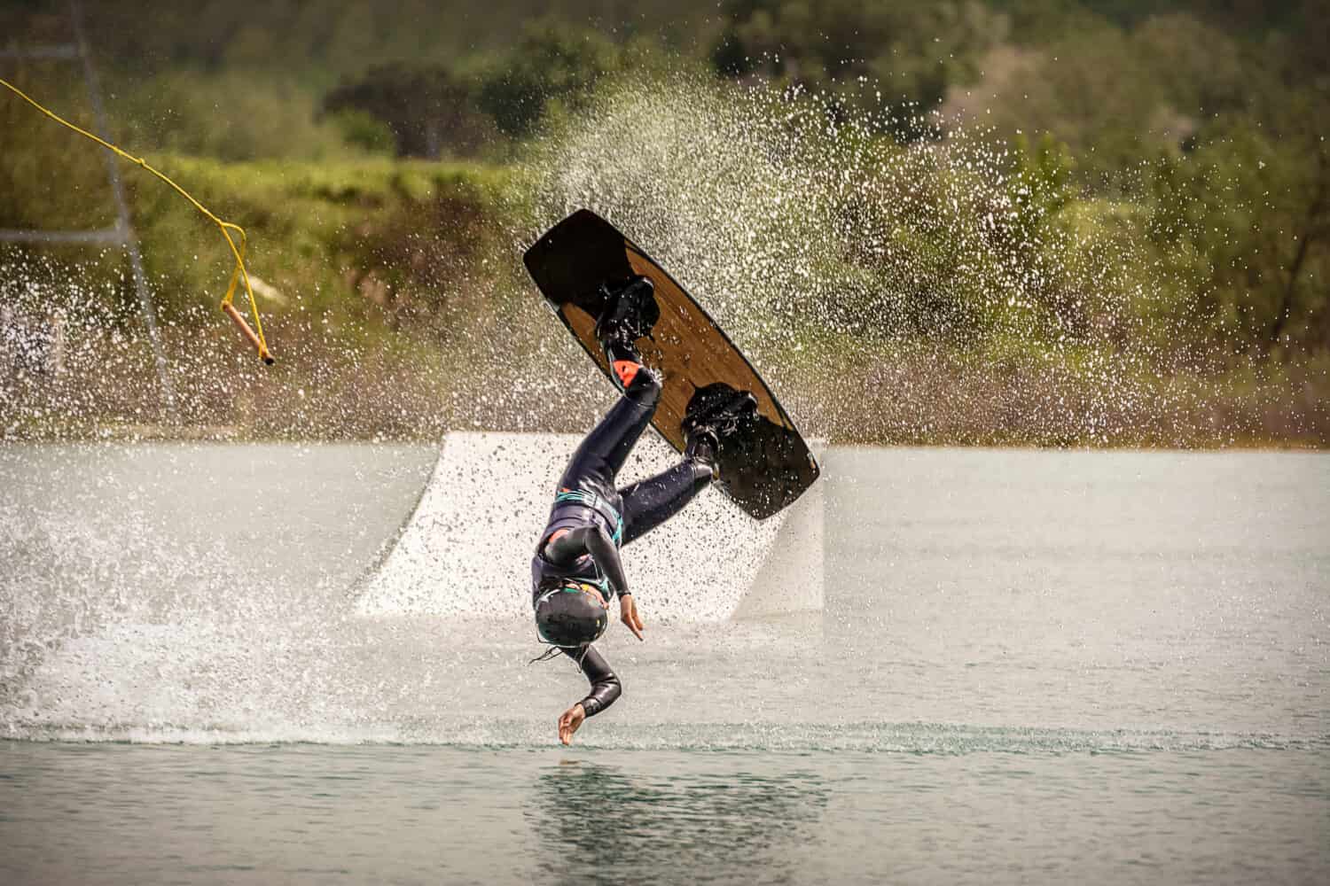 Athlete Woman is crashing with Wakeboard at the Cable Park