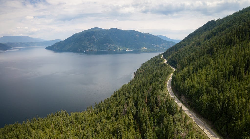 Aerial view of Trans-Canada Highway during a vibrant sunny summer day. Taken near Shuswap Lake, Sicamous, BC, Canada.