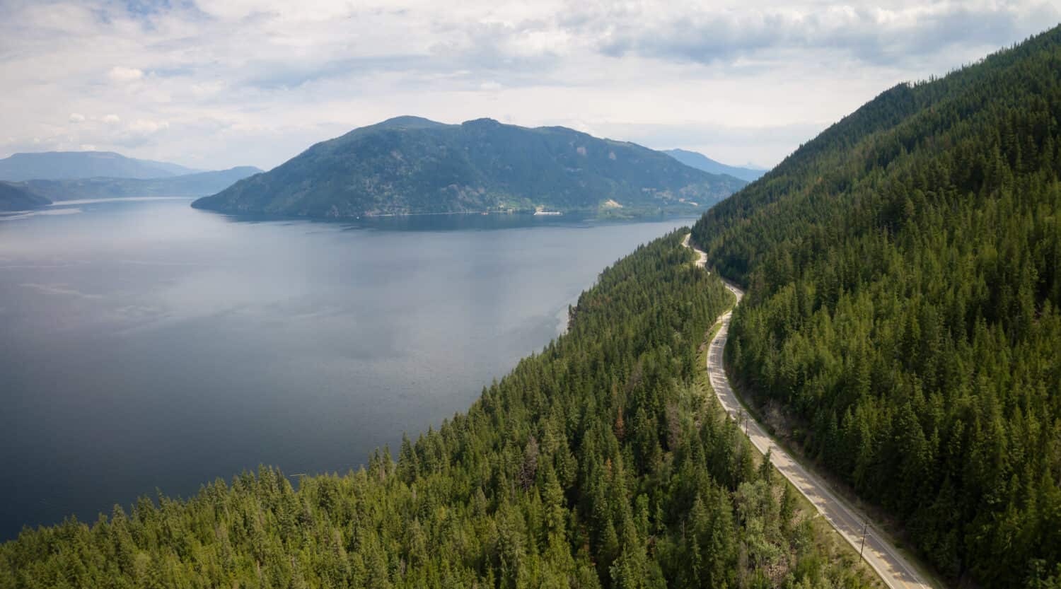 Aerial view of Trans-Canada Highway during a vibrant sunny summer day. Taken near Shuswap Lake, Sicamous, BC, Canada.