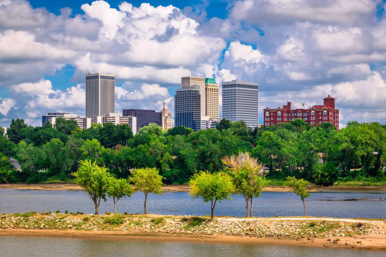 Tulsa, Oklahoma, USA downtown skyline on the Arkansas River in the afternoon.
