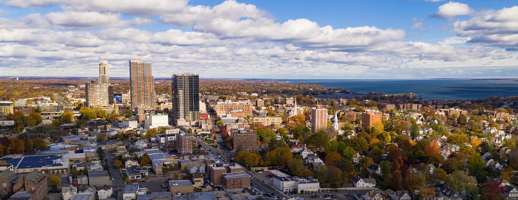 The Sun breaks through clouds hitting and illuminating the urban core of New Rochelle New York