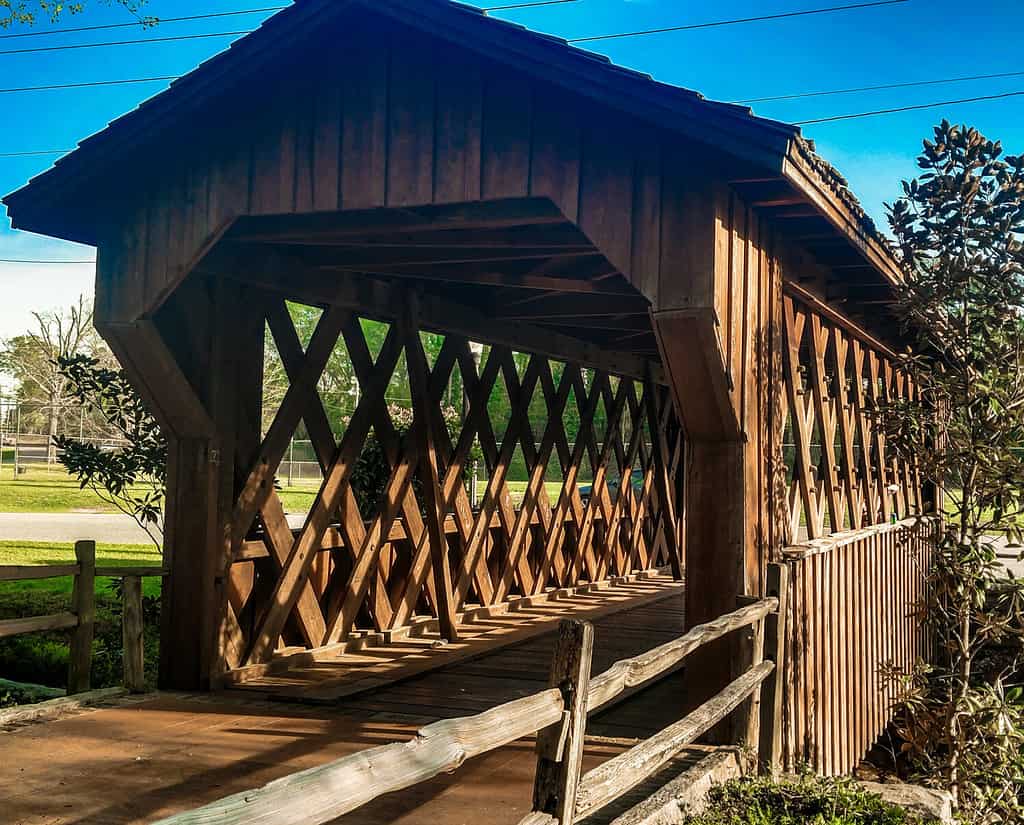 This is a wooden covered bridge in Municipal Park, Opelika, AL