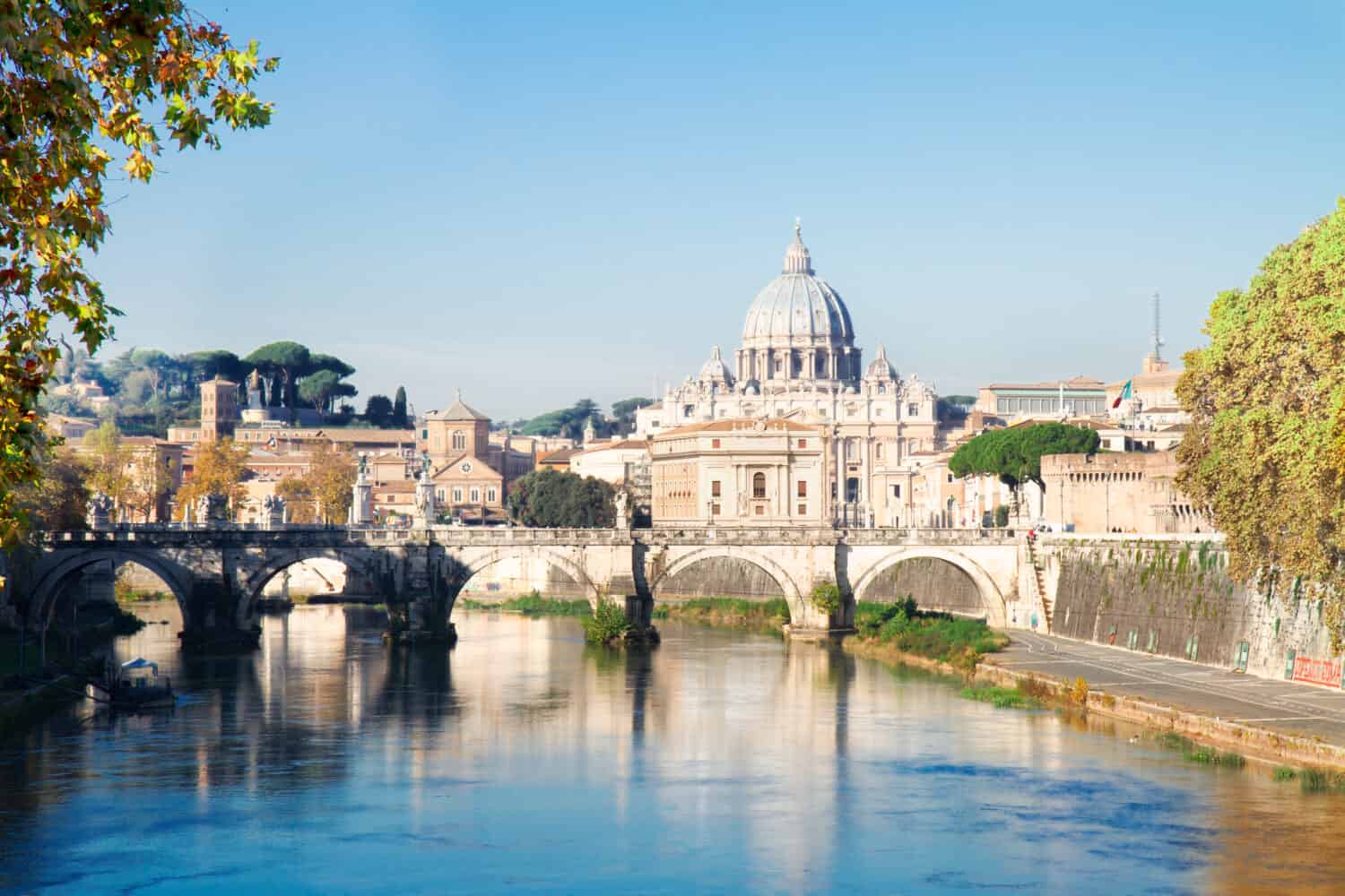 St. Peter's cathedral over bridge and Tiber river in Rome at summer, Italy