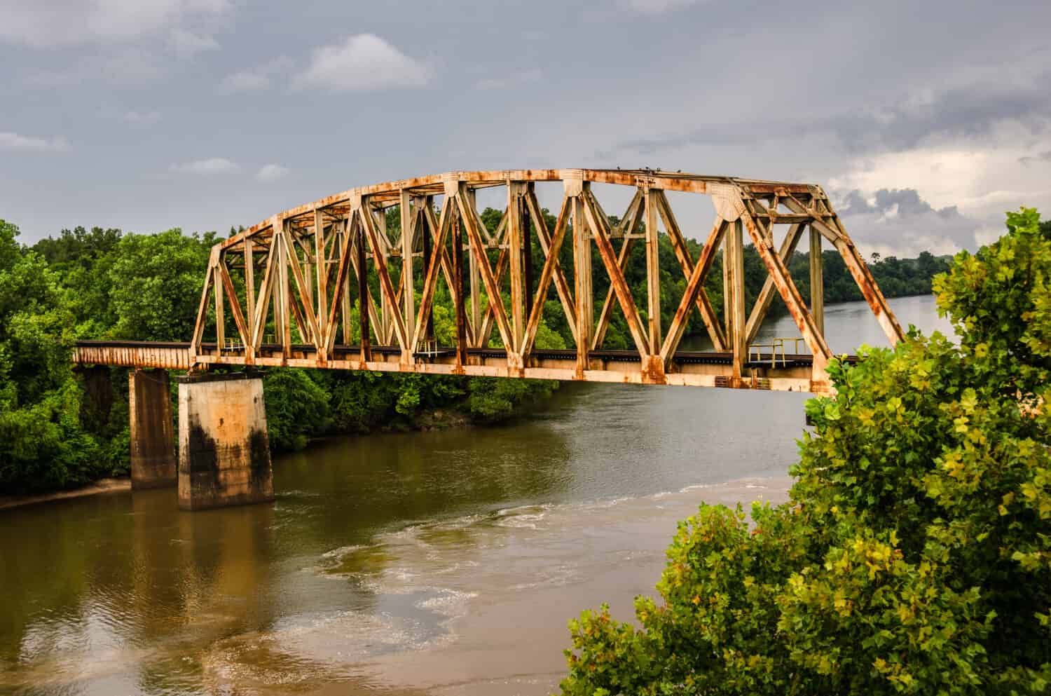 Rusty old railroad bridge spans the Chattahoochee River on the Georgia/Alabama border
