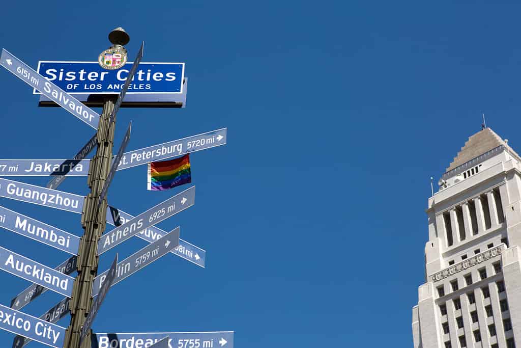 Street sign with the sister cities of Los Angeles and City Hall building