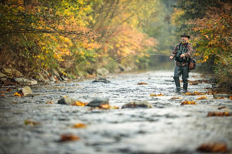 Fly fisherman fly fishing on a splendid mountain river