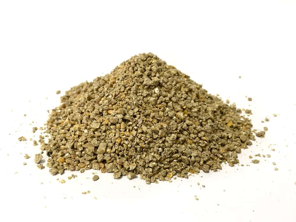 Poultry crumble pellet feed on white background for small chicken Broiler , Breeder and pullet