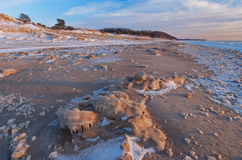 Winter landscape of the frozen shoreline of Lake Michigan at sunset, Saugatuck Dunes State Park, Michigan, USA
