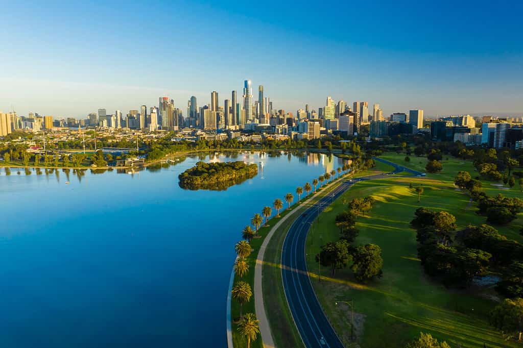 Aerial photo of beautiful park with lake and Melbourne CBD at sunrise