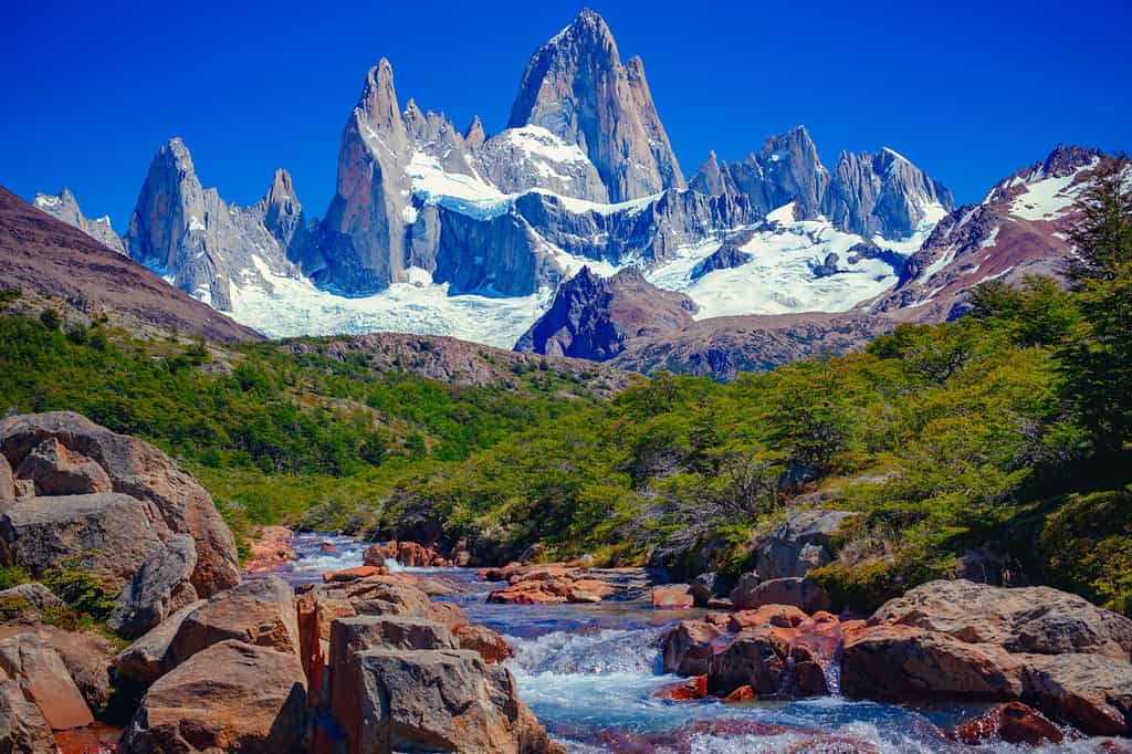 A unique and beautiful scenery: a blue river in El Chaltén, Patagonia, and Mount Fitz Roy in the background. Located at the Southern Patagonic Andes between Chile and Argentina.