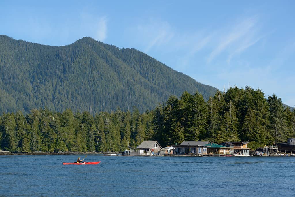 Kayaking in front of float homes, Tofino , British Columbia, Canada