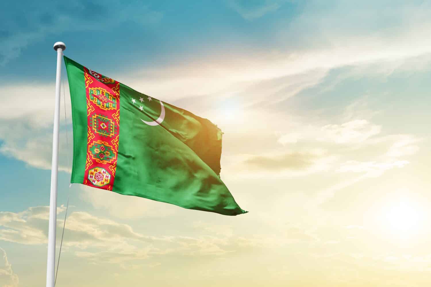 Turkmenistan national flag waving in beautiful clouds.