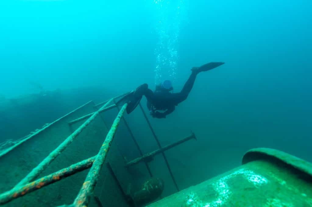 Diver exploring lake shipwreck 