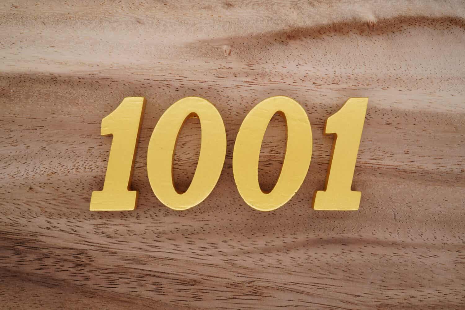 Wooden  numerals 1001 painted in gold on a dark brown and white patterned plank background.