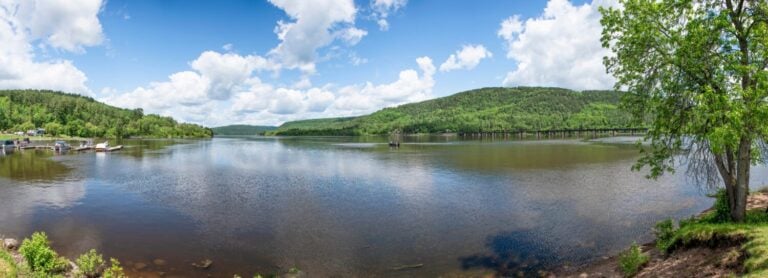 A panoramic view of a small marina at Mattawa, Ontario's waterfront where the Ottawa River meets the Mattawa River on a beautiful sunny day.