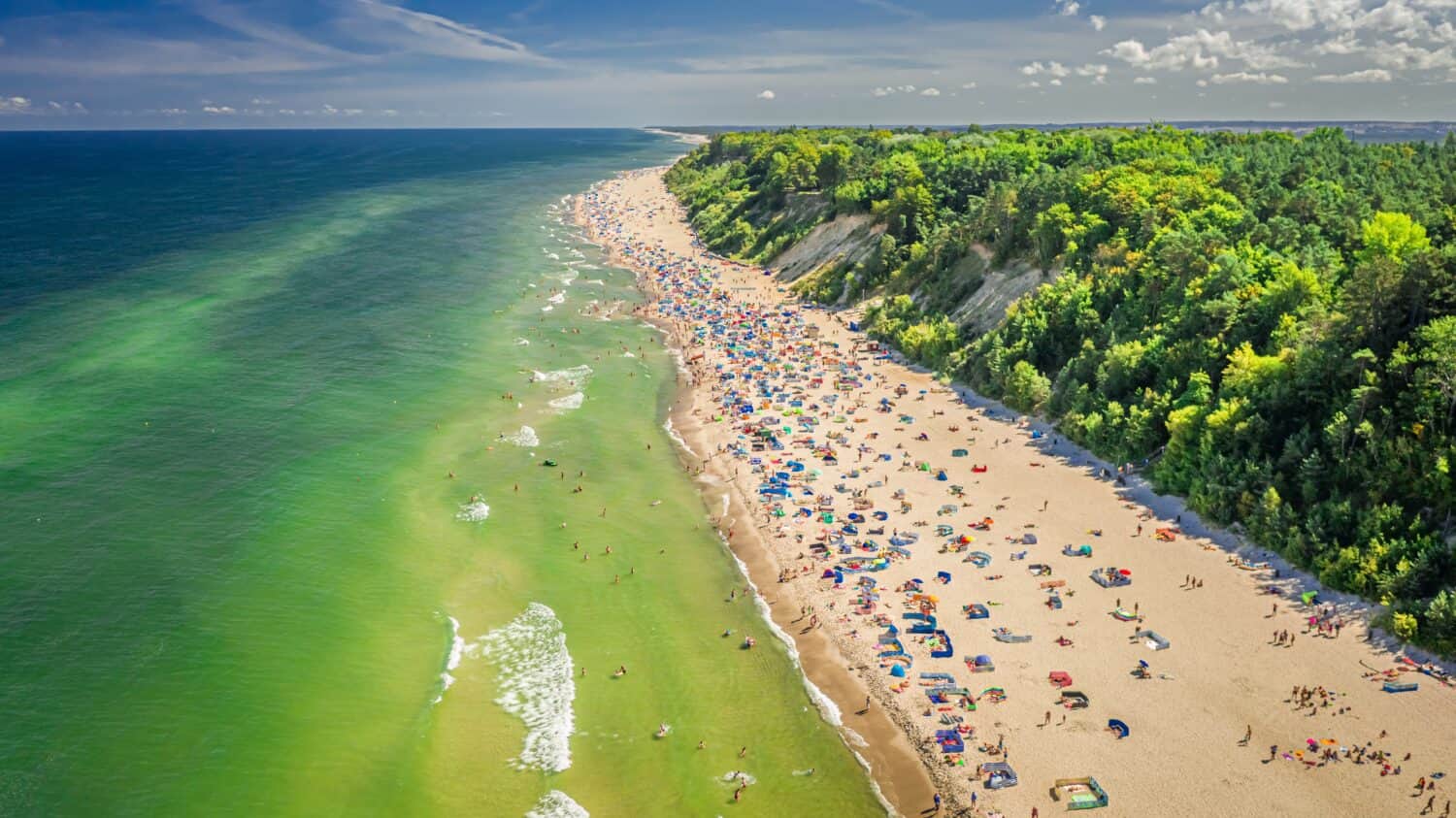 Crowded beach at Baltic Sea in Poland, Europe. Tourism at sea.