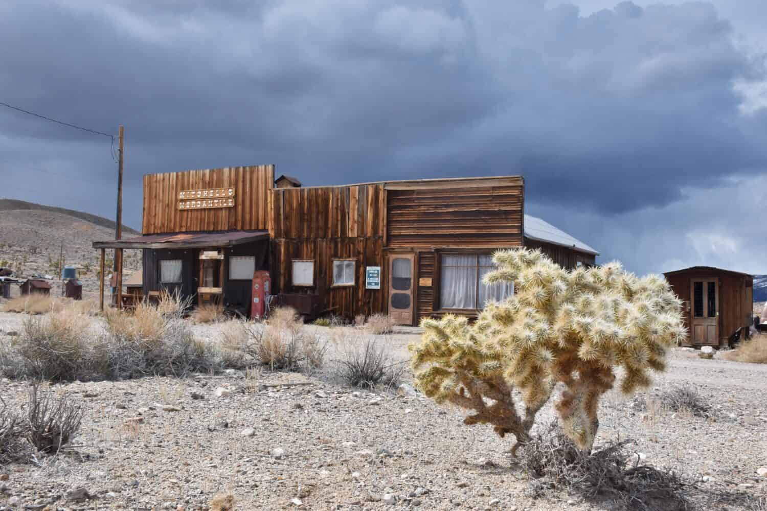 Gold Point in Nevada, USA. A ghost town with many abandoned houses, cars and no people. Background for horror movies. Famous spot in United States. Cloudy, blue sky.