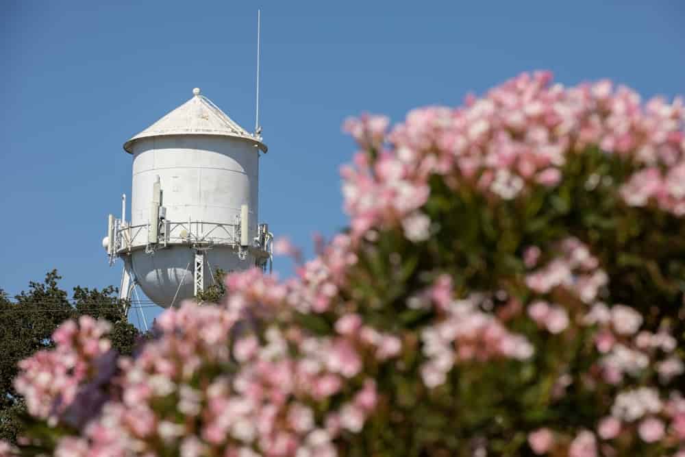 Afternoon sun shines on a historic downtown water tower of Elk Grove, California, USA.