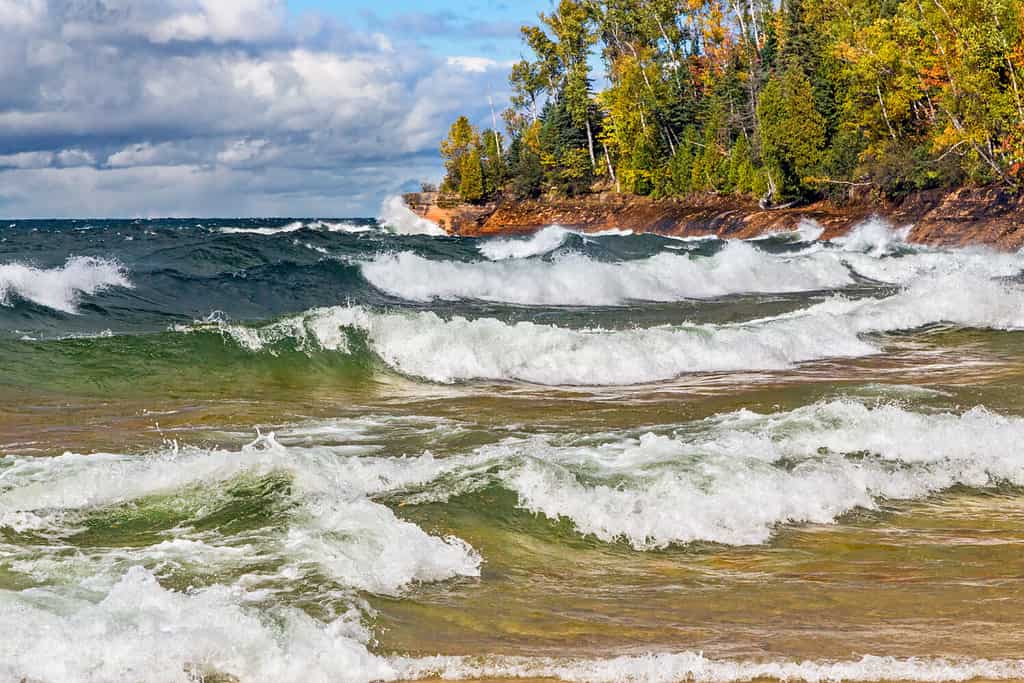 Waves crash on the rocky coast of Lake Superior at Michigan's Pictured Rocks National Lakeshore in autumn. Shot in Michigan's Upper Peninsula not far from Munising.