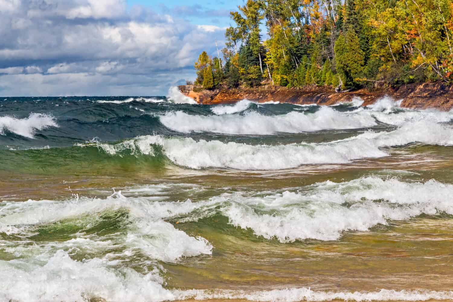 Waves crash on the rocky coast of Lake Superior at Michigan's Pictured Rocks National Lakeshore in autumn. Shot in Michigan's Upper Peninsula not far from Munising.