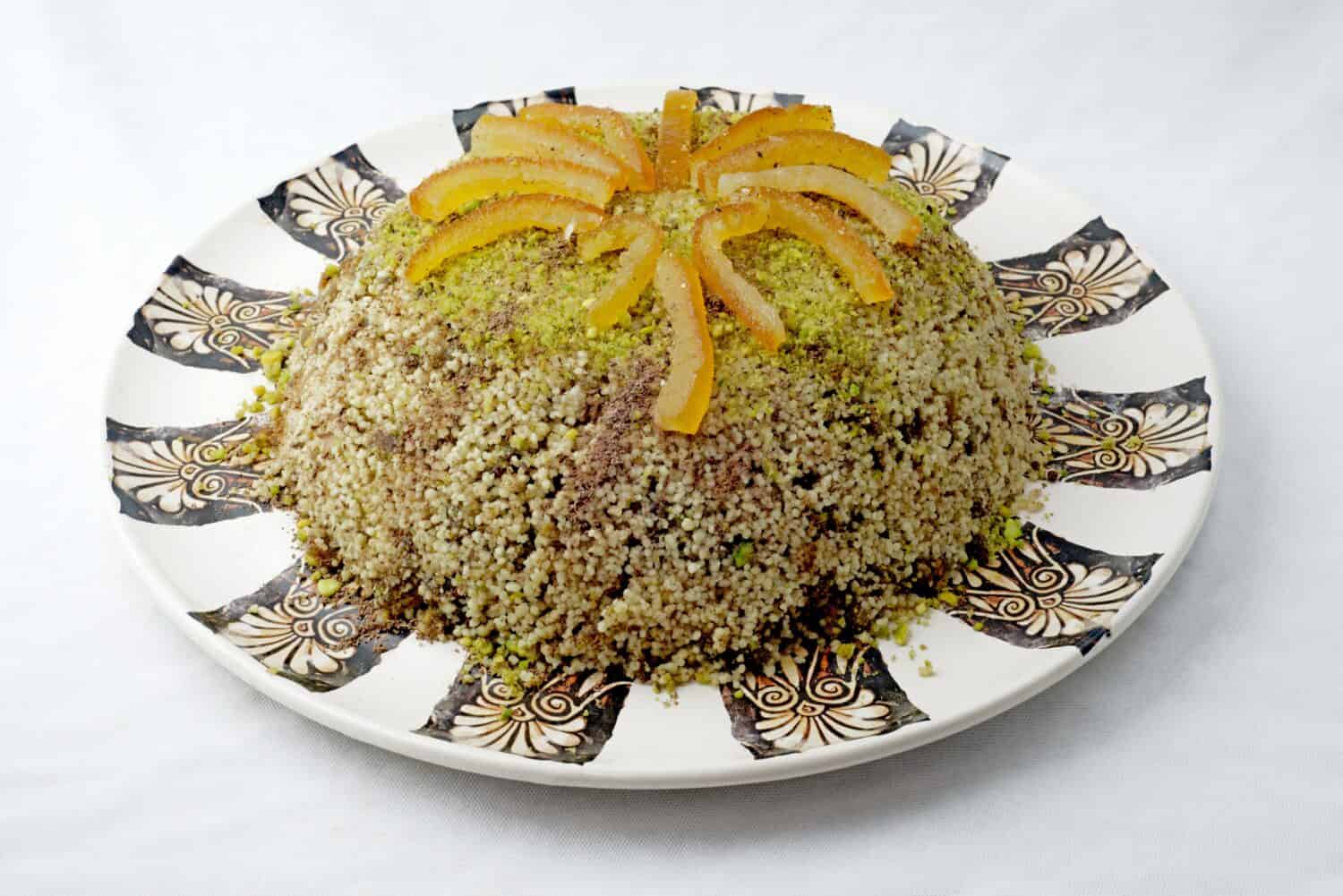 Sweet couscous with cinnamon, cocoa, almonds, pistachios and candied fruit. Typical food. 
