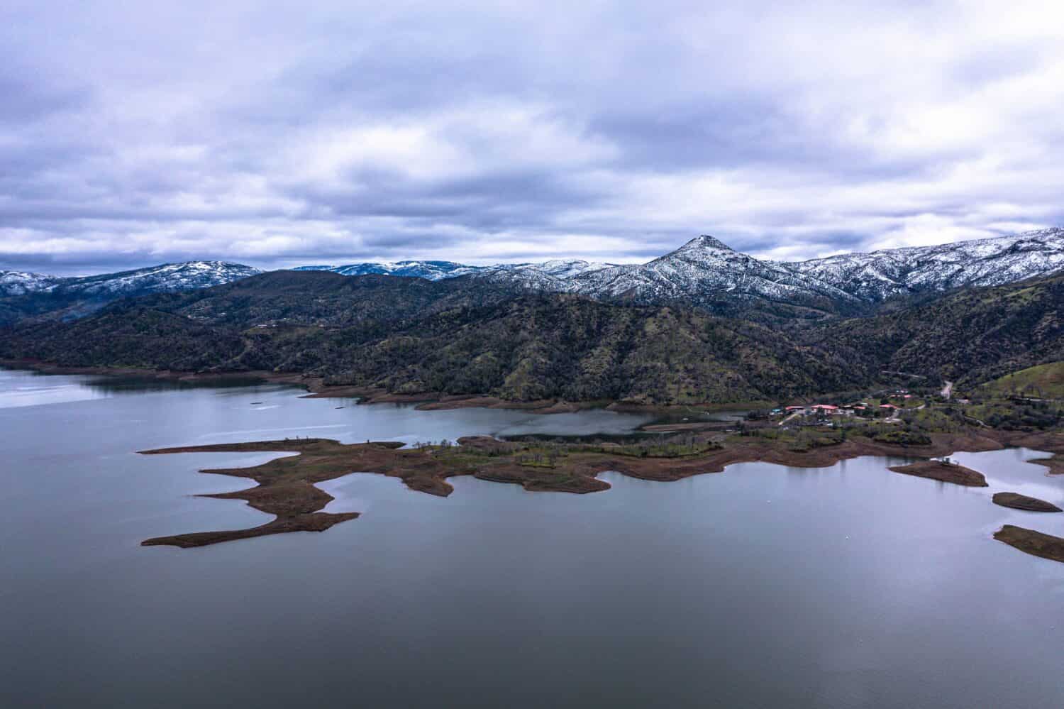 Lake Berryessa in Northern California with rare snowcapped hills all around