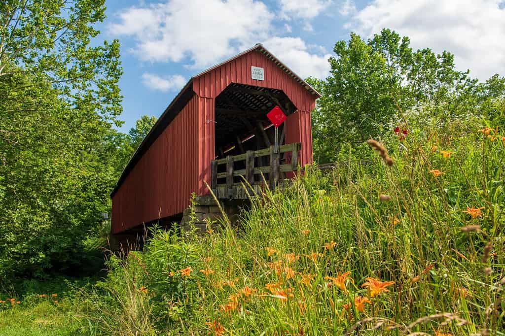 Bridge # 35-84-27 Hune Covered Bridge is a historic wooden covered bridge in the southeastern part of Ohio. Local bridge builder Rollin Meredith erected it in 1879, using the Long-truss style.