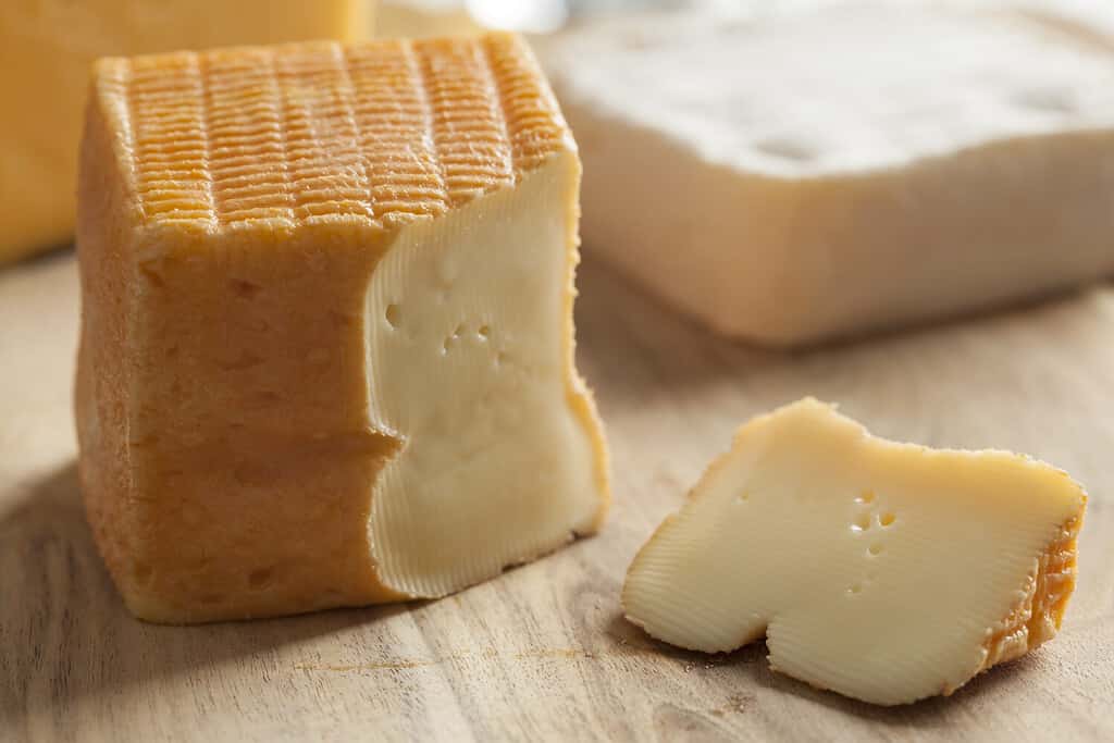 Piece of Belgian Limburger cheese on a cheese board