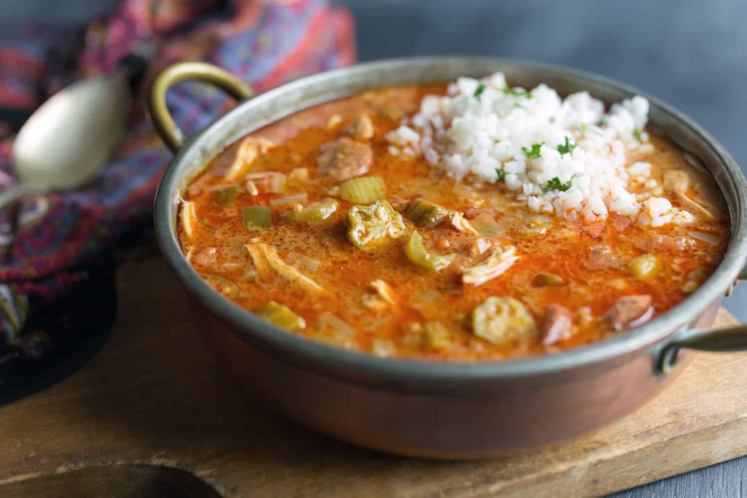 Homemade gumbo with rice in a copper pot. 