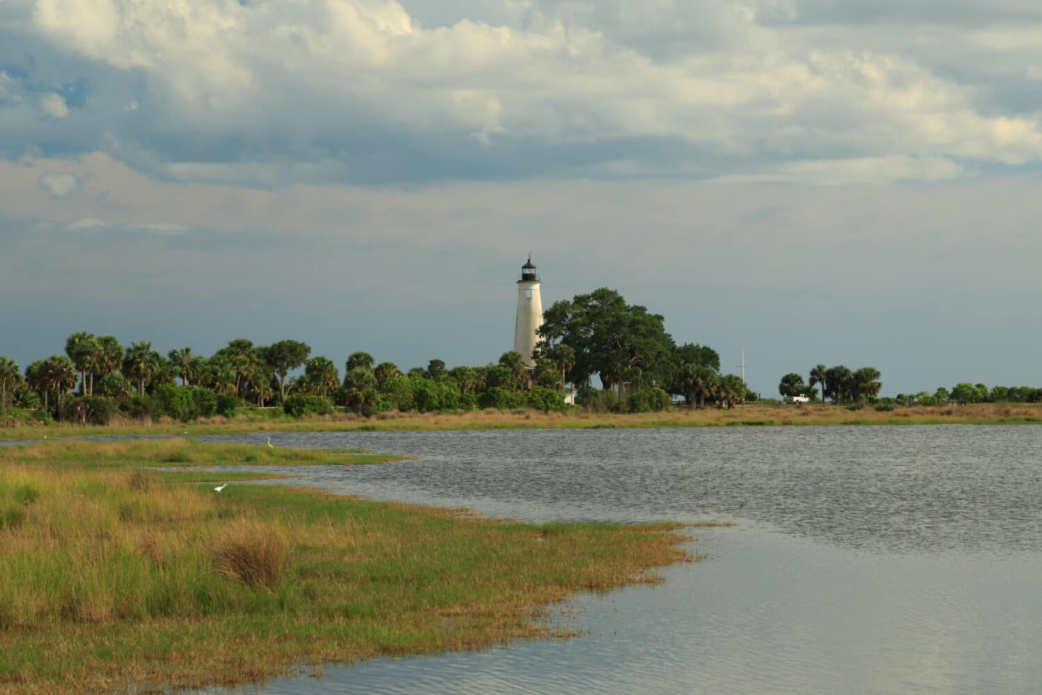 A landscape photograph of St. Marks Lighthouse in the National Wildlife Refuge near Tallahassee in Florida, USA. It is one of the oldest wildlife refuges in the United States.