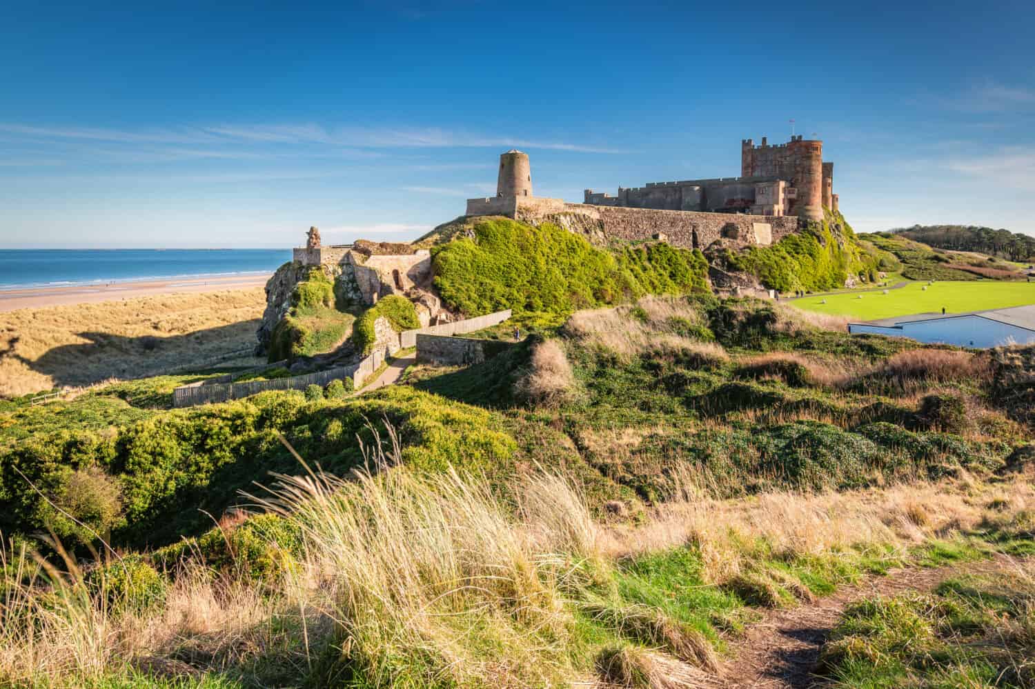 Elevated View of Bamburgh Castle / Bamburgh Castle viewed from an elevated hillock, on the Northumberland coastline