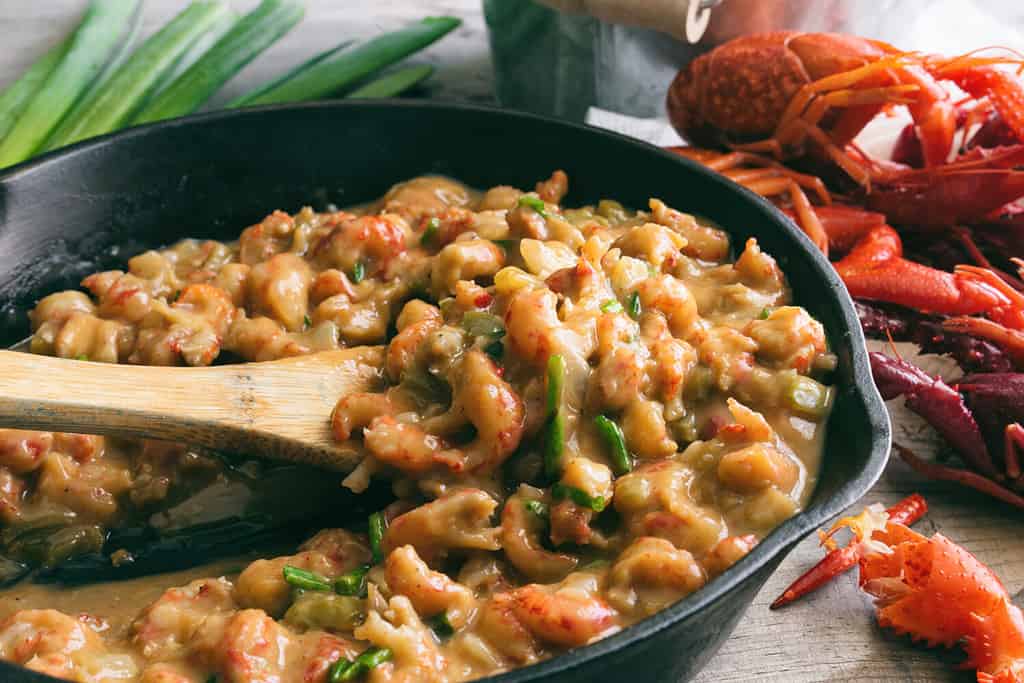 Crawfish étouffée being served in a cast iron skillet.