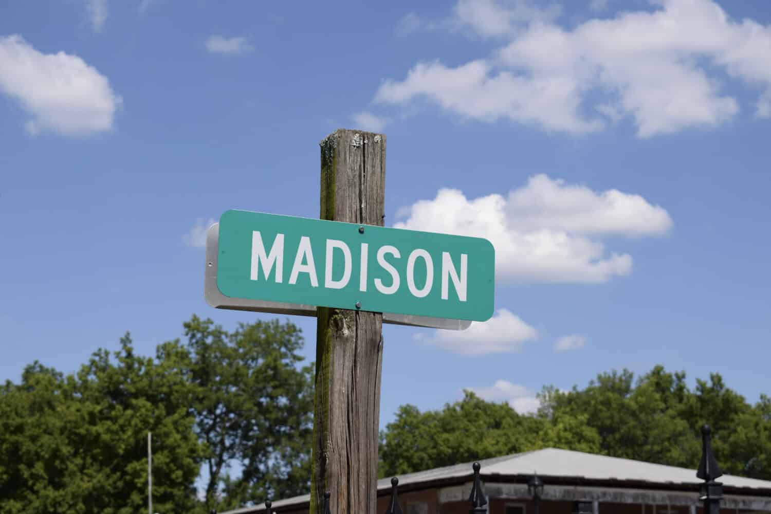 Madison city street sign in the clouds in downtown Madison, AL