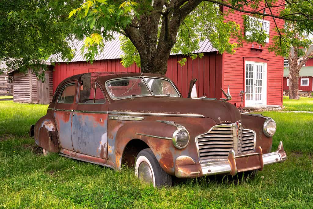 A Buick sits in front of a red building in Red Oak II in Jasper County, Missouri