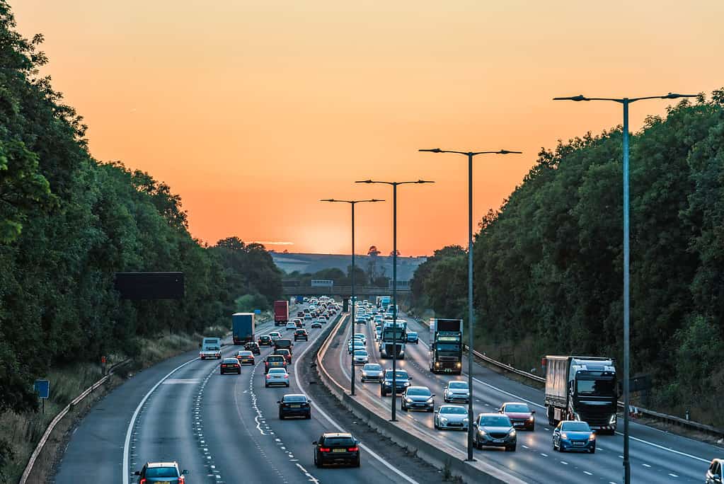 Sunset view of busy UK Motorway traffic in England