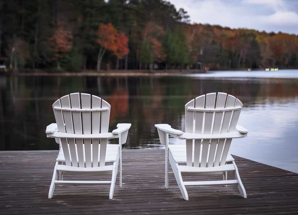 Two Muskoka chair on the dock in front of lake benoir, Harcourt, Ontario, Canada