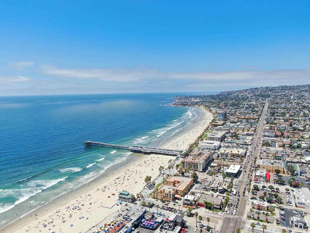Aerial view of people at the beach with the pier with during blue day, Pacific Beach, San Diego