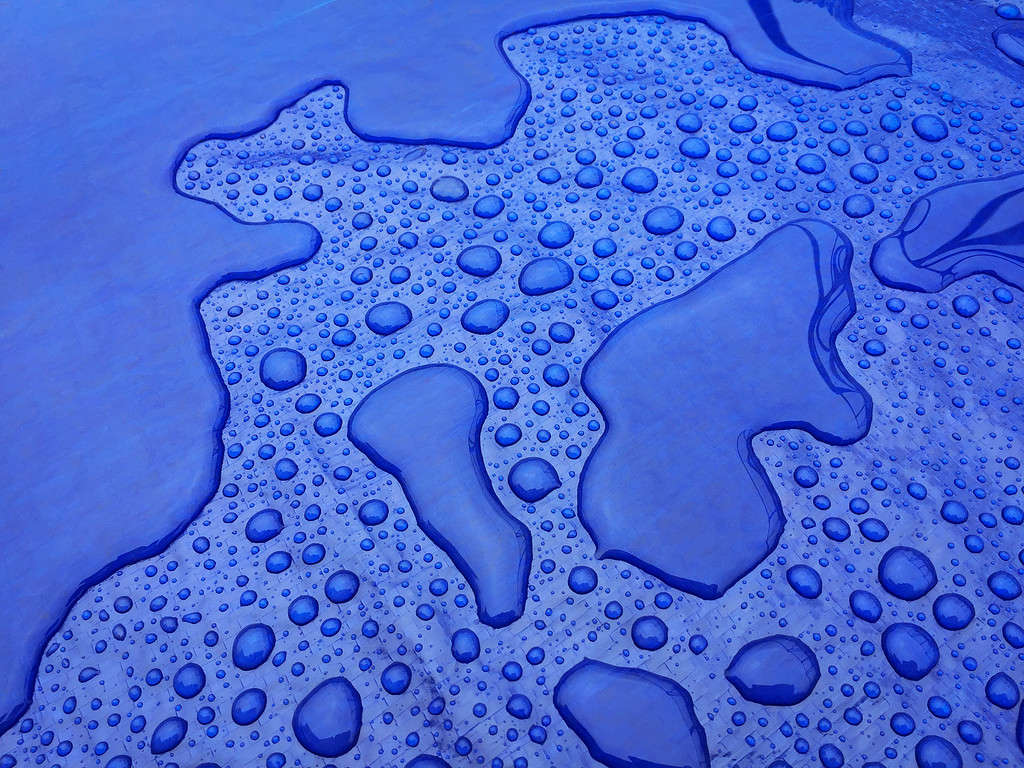 Droplets of rainwater on the blue tarp