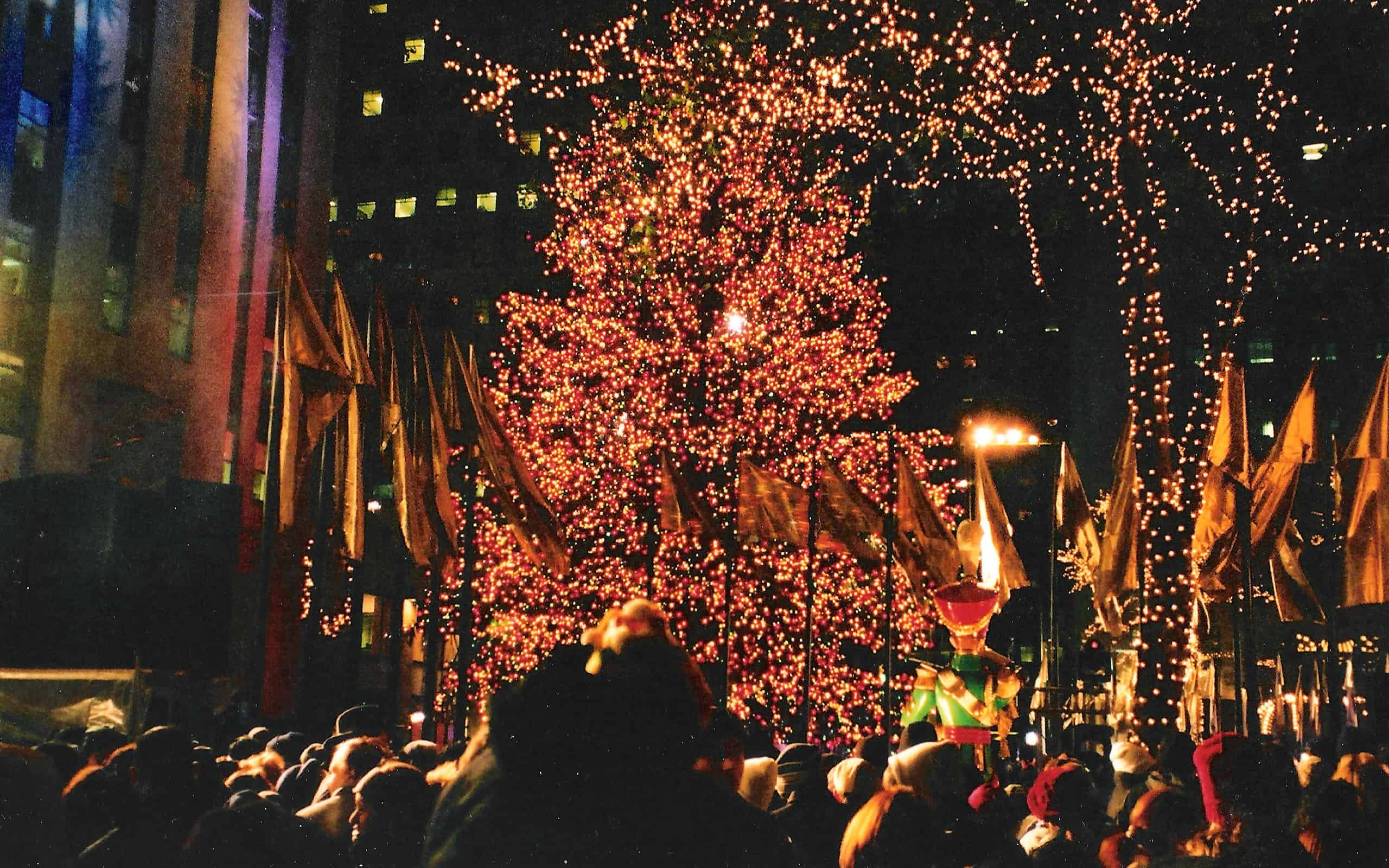 People enjoying the festivities around the unveiling of the Christmas Tree at Rockefeller Center, right after Thanksgiving.