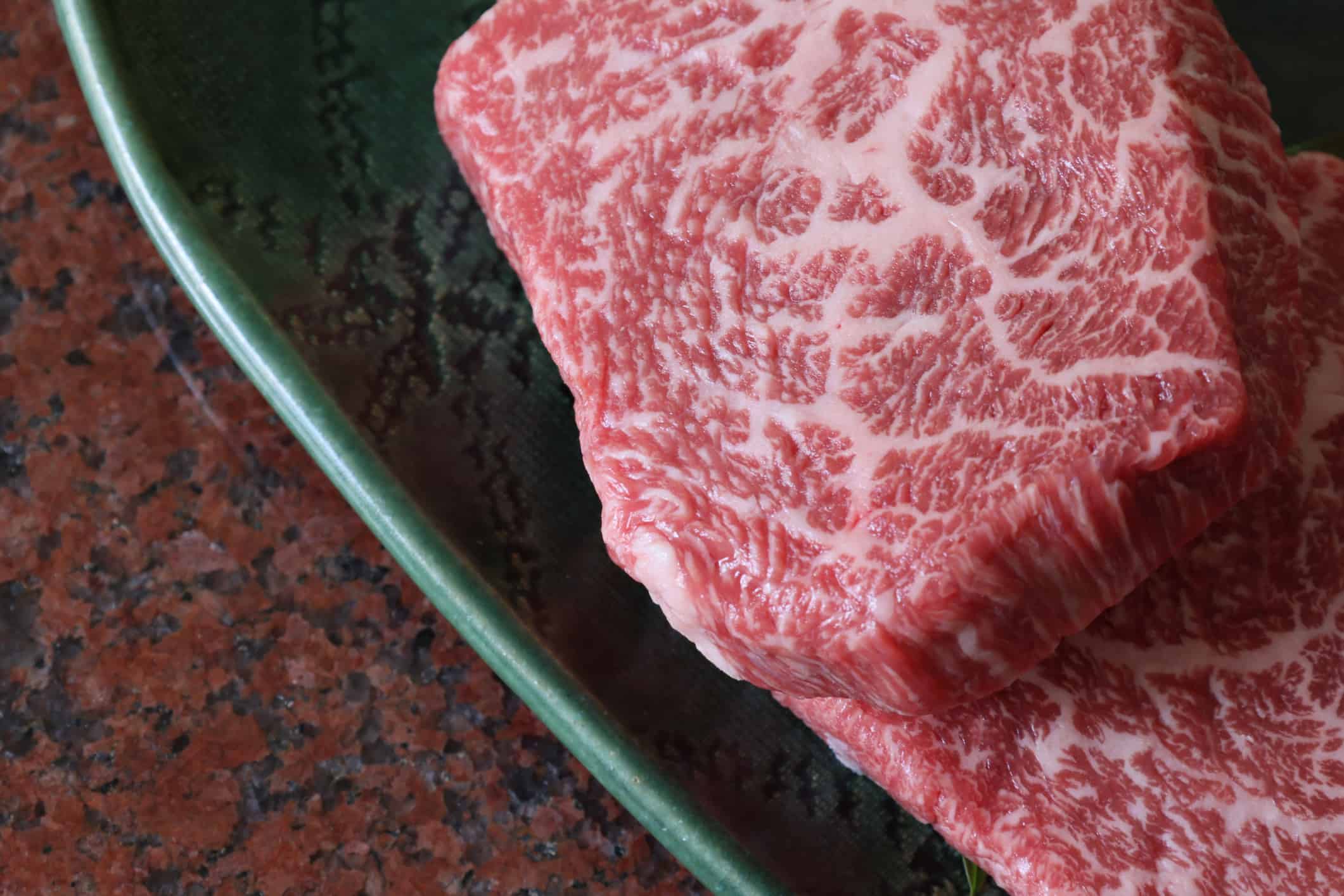 Kobe beef on a plate isolated on a marble plate.