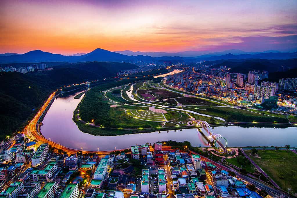 Aerial shot of cityscape and a beautiful river at sunset in Ulsan, South Korea