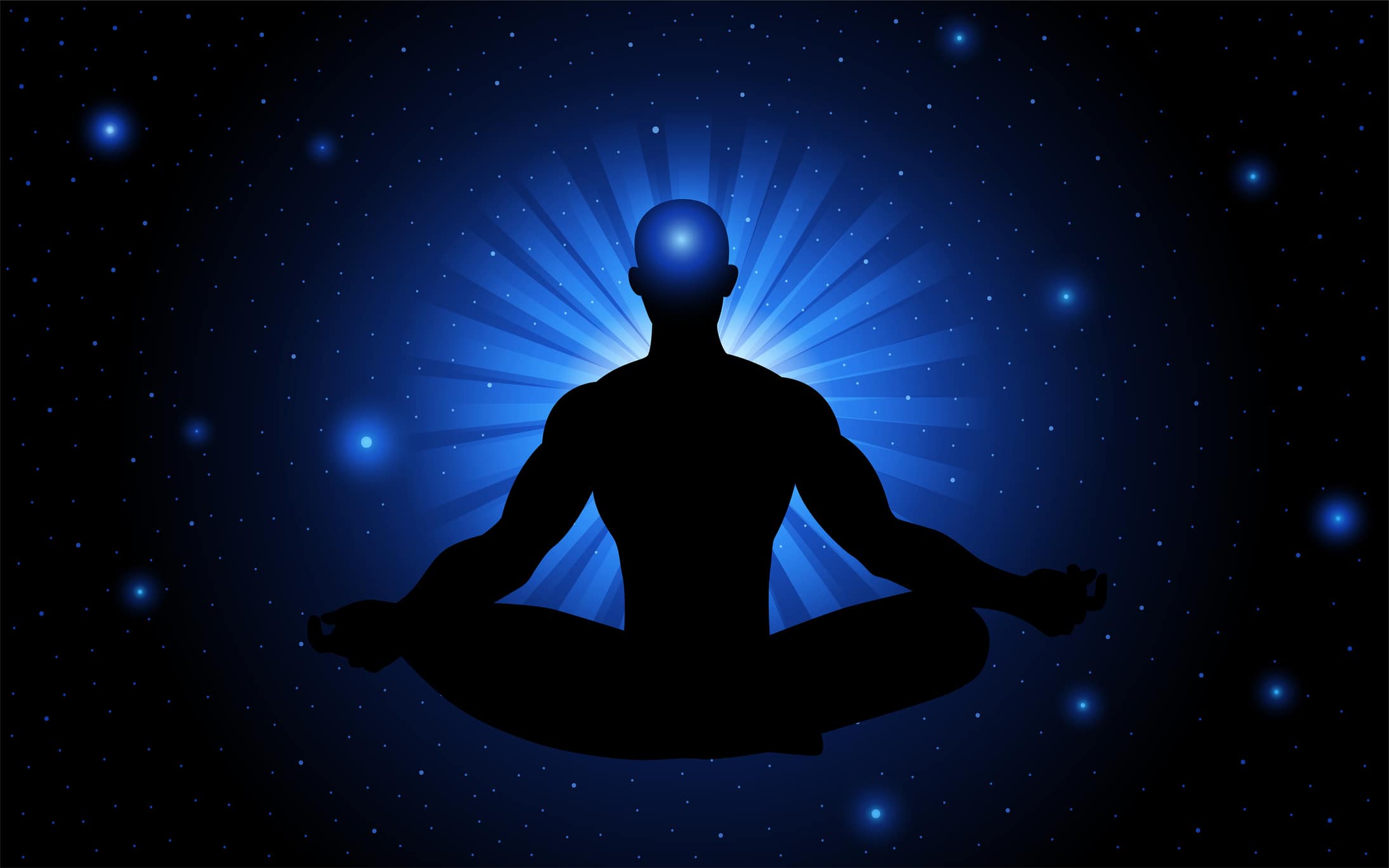 Silhouette of man in meditative position with a blue aura.