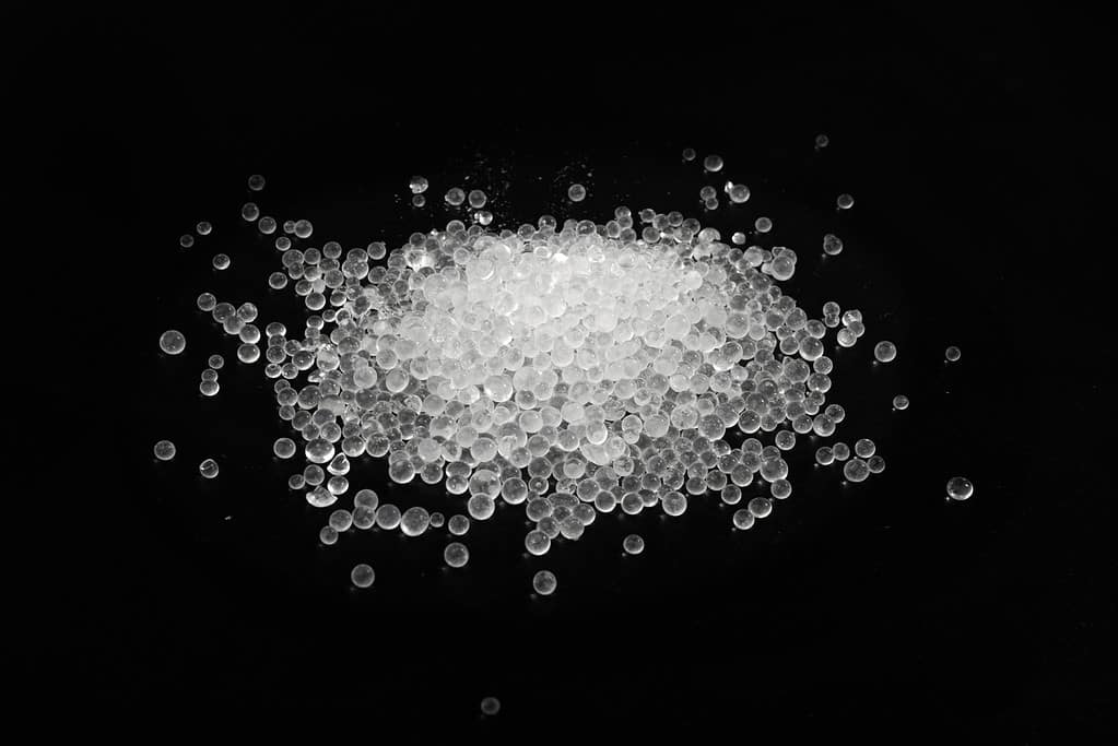 Desiccant Silica Gel Adsorbent Crystals on Black Background, Desiccant Polymer Balls