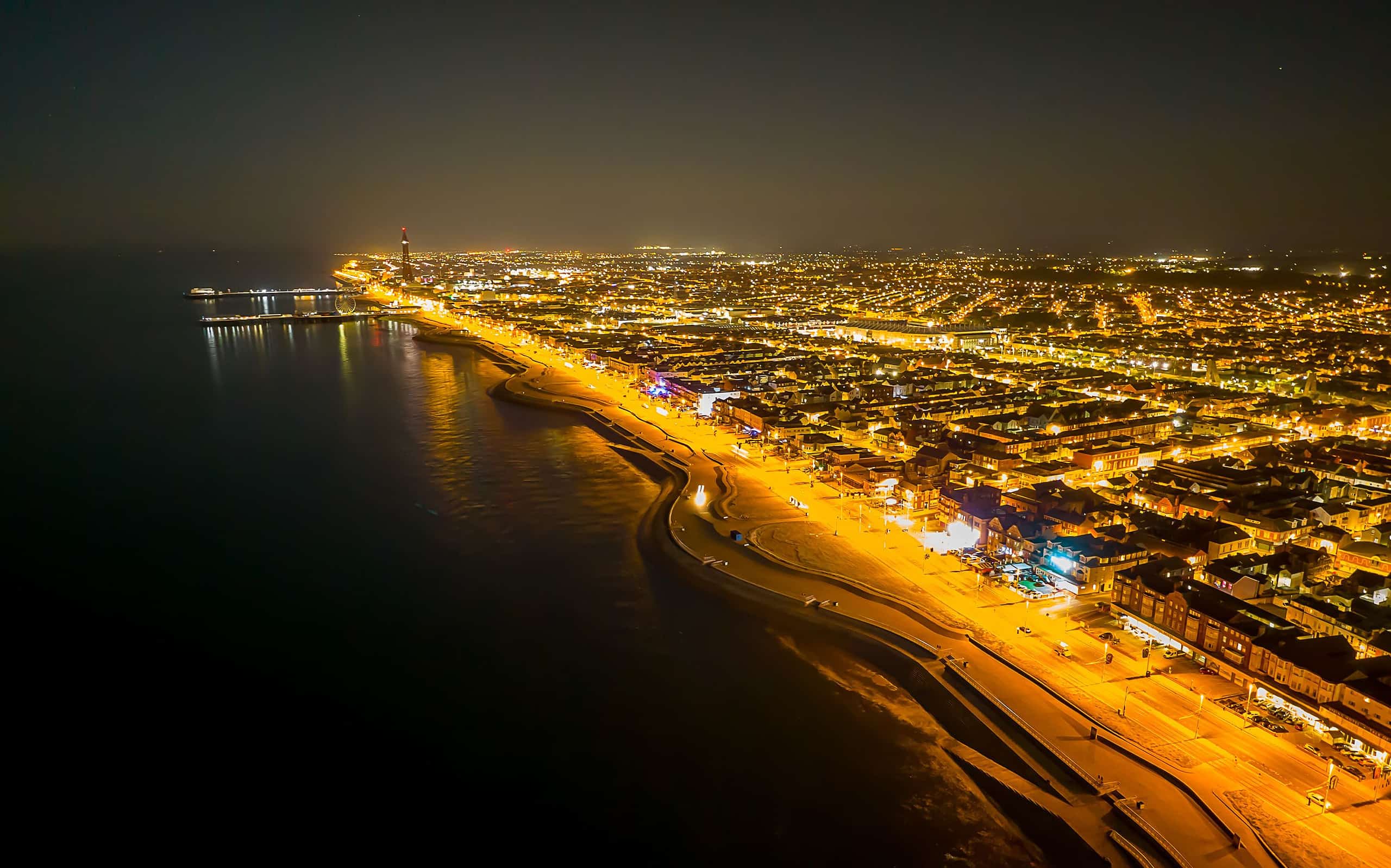 Aerial shot of Blackpool town illuminated with lights at night in England