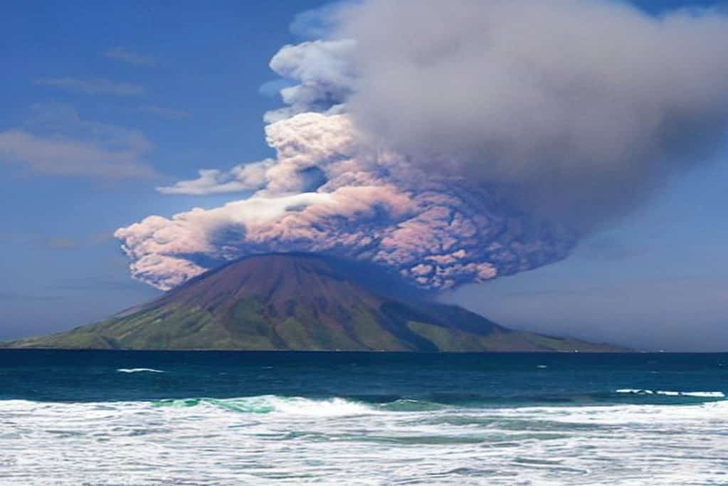 Paradise pacific island with erupting volcano