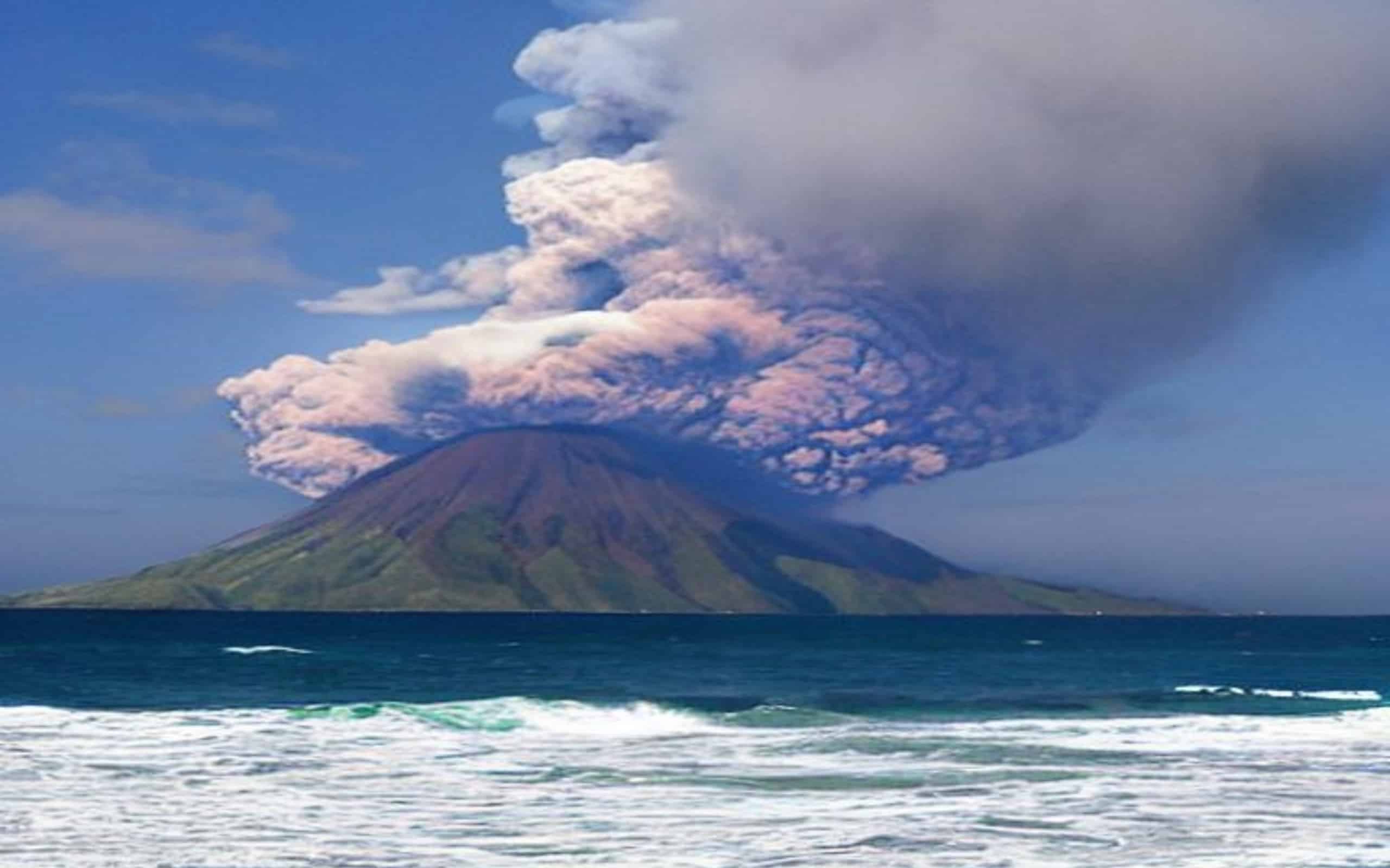 Paradise pacific island with erupting volcano