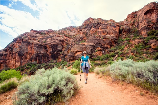 Senior Woman hiking in a beautiful red rock canyon