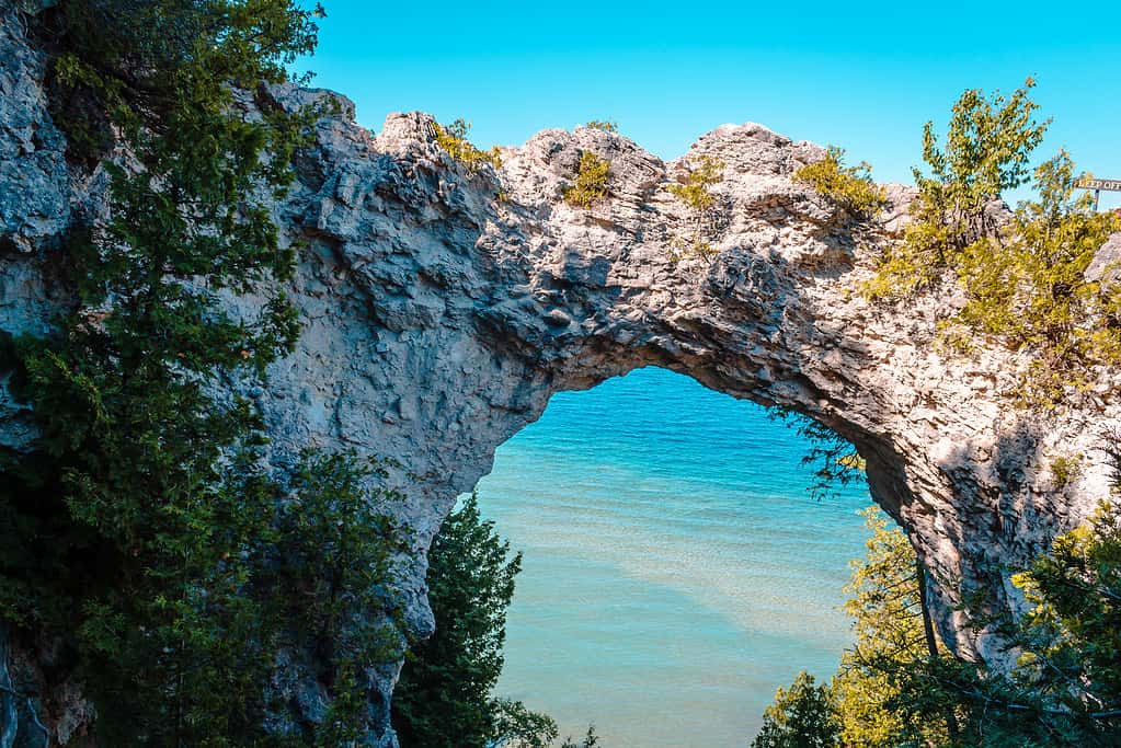 Landscape view of Arch Rock looking out over Lake Huron on Mackinac Island, most incredible rock formations in the united states
