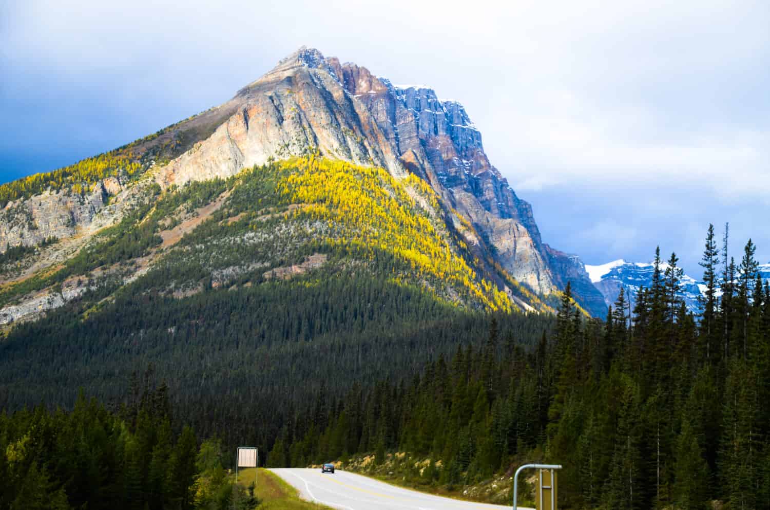 Mountain range of Kootenay National Park with yellow leaves and Kootenay Highway in Autumn, Canadian Rockies, British Columbia, Canada
