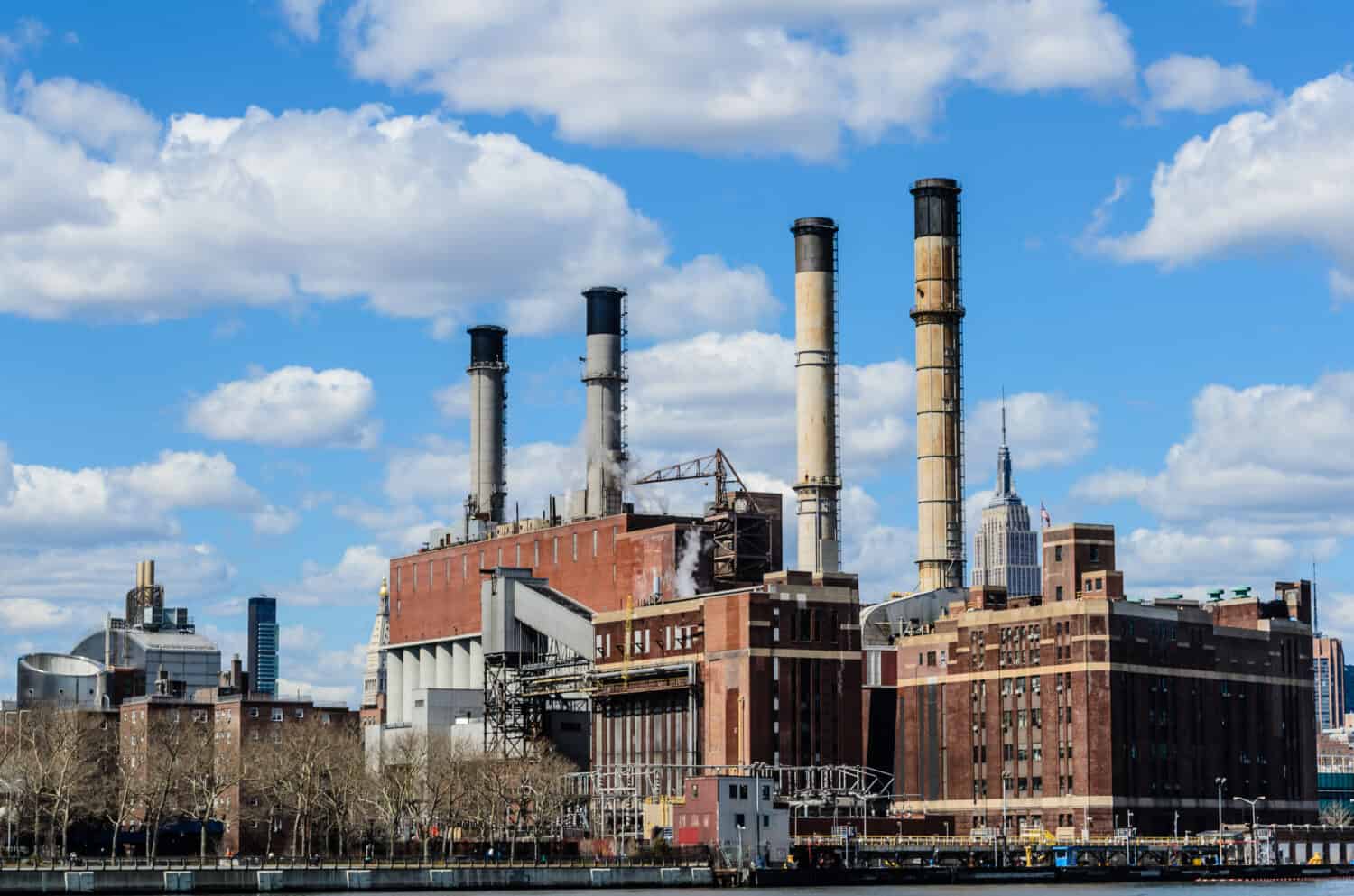 Industrial buildings against blue sky. Manhattan, New York, USA, America